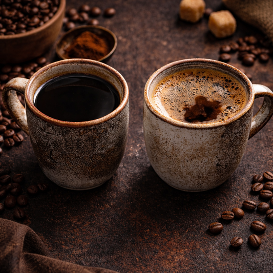 Two ceramic mugs of dark coffee on a rustic surface, showing bold smooth coffee beside a foamy, more bitter-looking brew.