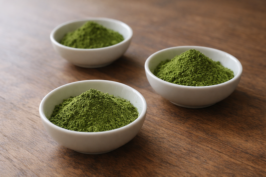Ceremonial matcha powder in white ceramic bowls on a wooden table
