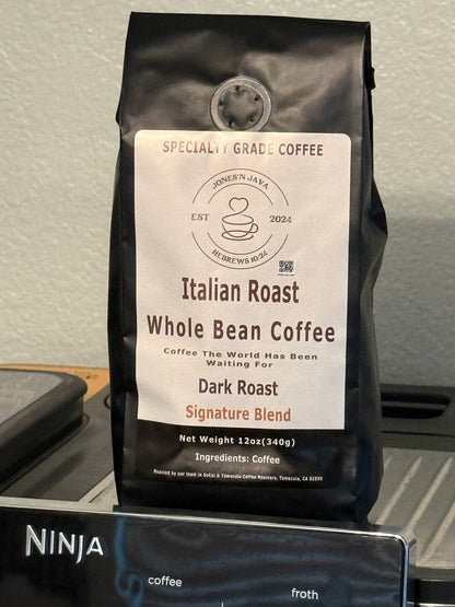 Italian Roast whole bean coffee by Jones’N Java on a kitchen counter with a coffee machine in the background.