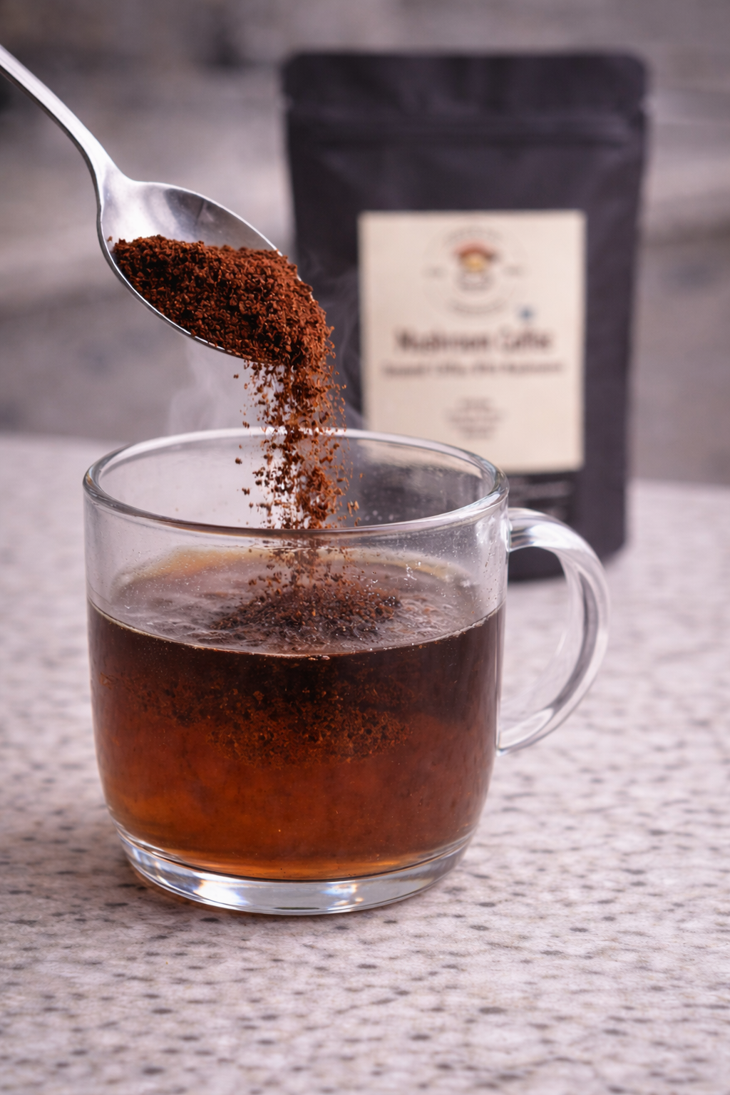 Ground mushroom coffee being poured into a glass mug of hot water, creating a smooth instant coffee experience