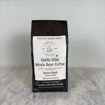Vanilla Vibes whole bean coffee medium roast flavored coffee bag by Jones’N Java on marble countertop