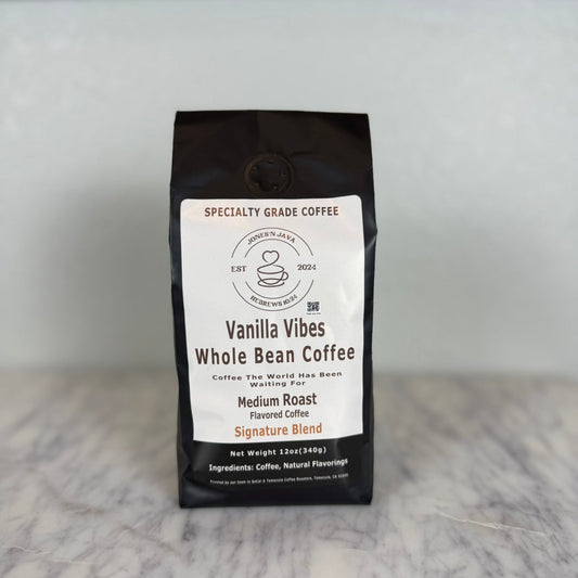 Vanilla Vibes whole bean coffee medium roast flavored coffee bag by Jones’N Java on marble countertop