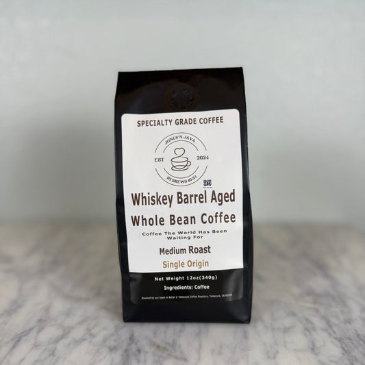 Whiskey barrel aged whole bean coffee medium roast single origin coffee bag by Jones’N Java on marble countertop